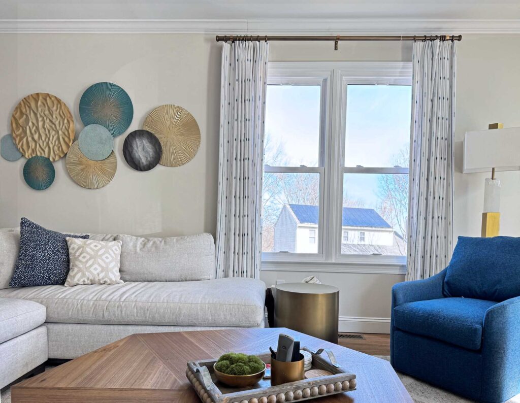 family room design featuring custom window treatments, furniture, metal art